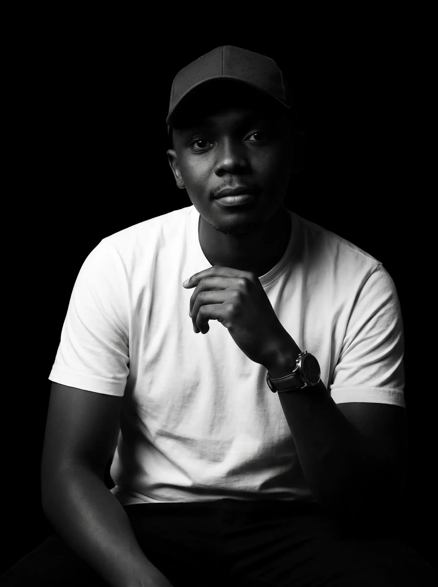 Humphrey Kibet, graphic designer, in a white T-shirt and black cap